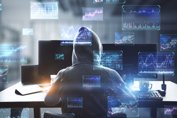 hacker and abstract screens implying investment fraud and cyber theft