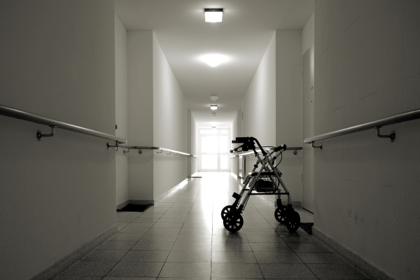 elderly walker in empty halls of a nursing home